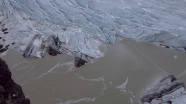Aerial view of glacier and lake with iceberg floating on the water on a winter day in Iceland - Nature and travel concepts.