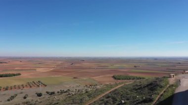 Aerial view of windmills in the countryside in Spain - White windmills in Castilla La Mancha region on a sunny day - Travel destinations and industrial architecture in southern Europe