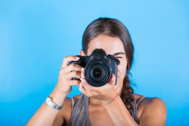 Young woman taking pictures with a professional camera