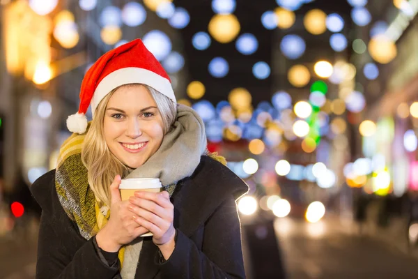 Beautiful young woman wearing Santa hat in London — Stock Photo, Image