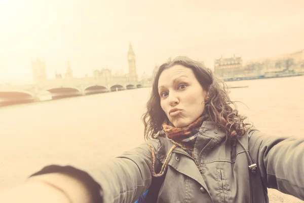 Beautiful woman taking a selfie in London