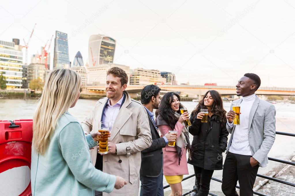 Business group drinking beer after work in London