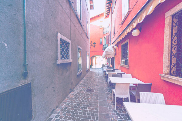 Empty street cafe in Italy during quarantine in faded color effect.