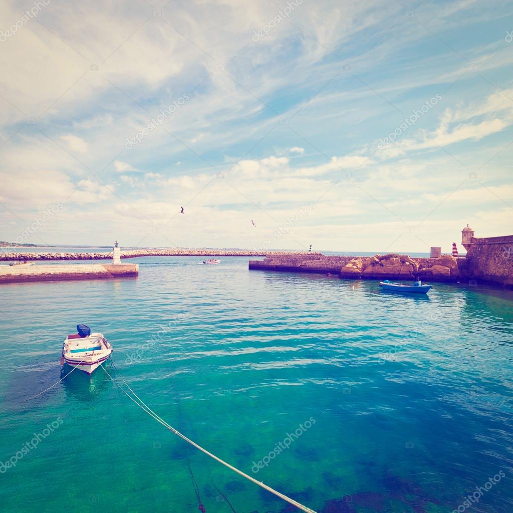 Boat in a Quiet Harbor on the Atlantic Coast of Portugal, Vintage Style Toned Picture