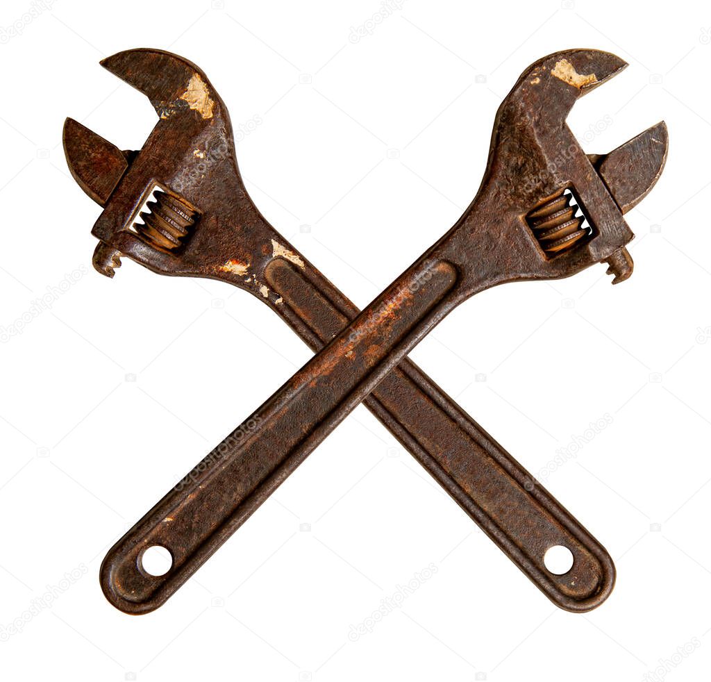 Two old rusty plumbing adjustable wrenches crossed and isolated on white background 