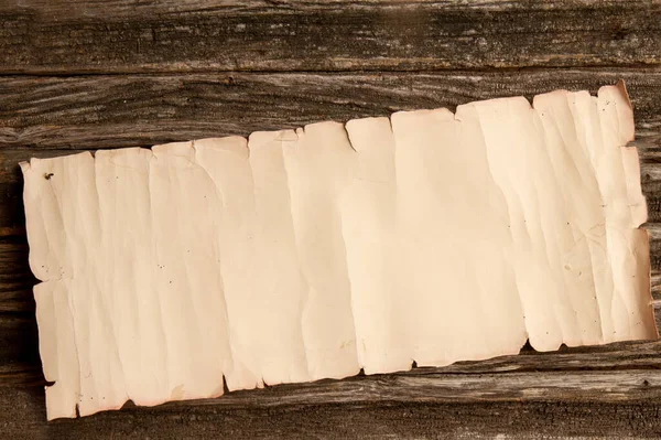 Eski, buruşuk kağıt tomarı kaba ahşap bir masada yazı için yer var. Boş arkaplan