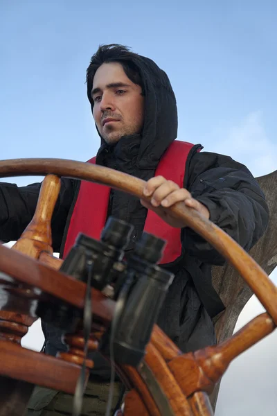 Young sailor steering tall ship — Stock Photo, Image