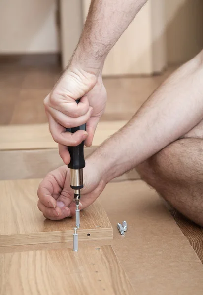 Hands with a screwdriver — Stock Photo, Image