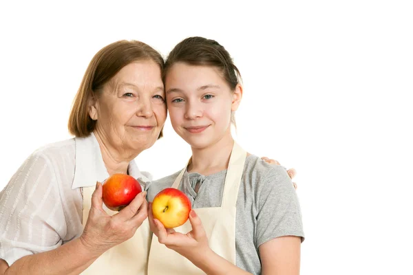 The grandmother and the granddaughter hold beautiful apples — Stock Photo, Image