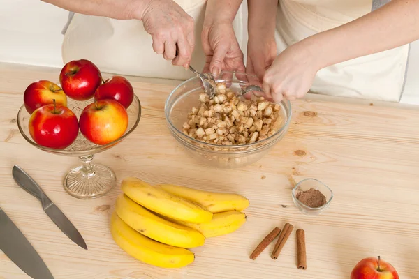 Hands of the grandmother and hand of the granddaughter stir ingr — Stock Photo, Image