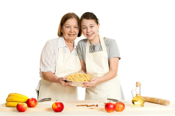 The grandmother and the granddaughter hold beautiful pie — Stock Photo, Image