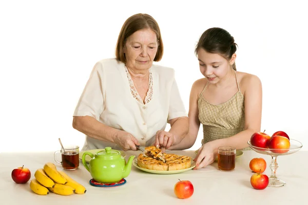 The grandmother treats the granddaughter — Stock Photo, Image