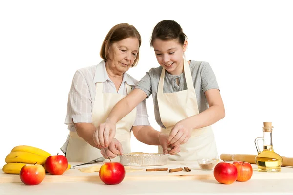 The grandmother and the granddaughter stack dough strips — Stock Photo, Image