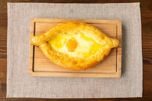 Homemade Ajarian Khachapuri with Sulguni Cheese Filled with a Raw Egg and Melted Butter Close Up. — Stock Photo, Image