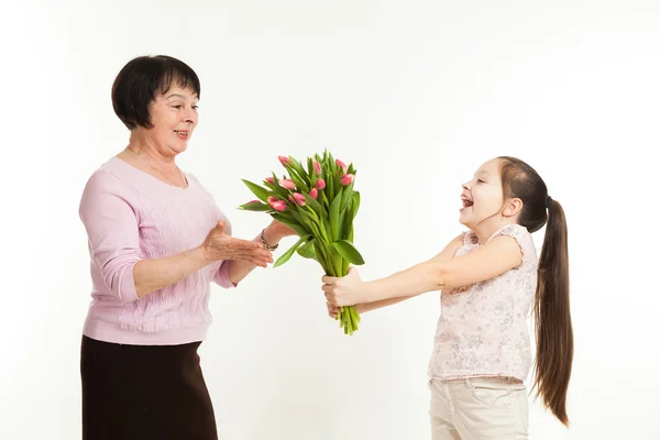 The granddaughter congratulates the grandmother — Stock Photo, Image