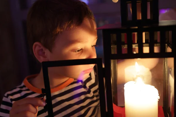 Boy looking at candle — Stock Photo, Image