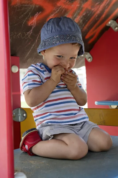 Toddler in wooden toy house — Stock Photo, Image