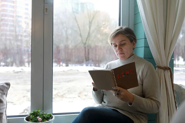 窗台上有记事本的女人的画像 — 图库照片