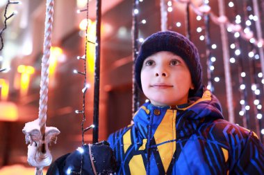 Geceleri parlayan çelenklerin arkasındaki çocuk, Kazan.