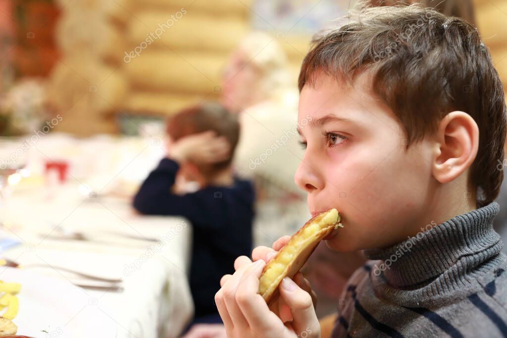 Child eating Qistibi with potato in tatar restaurant