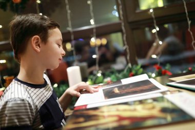 Çocuk portresi kafede inceleniyor.