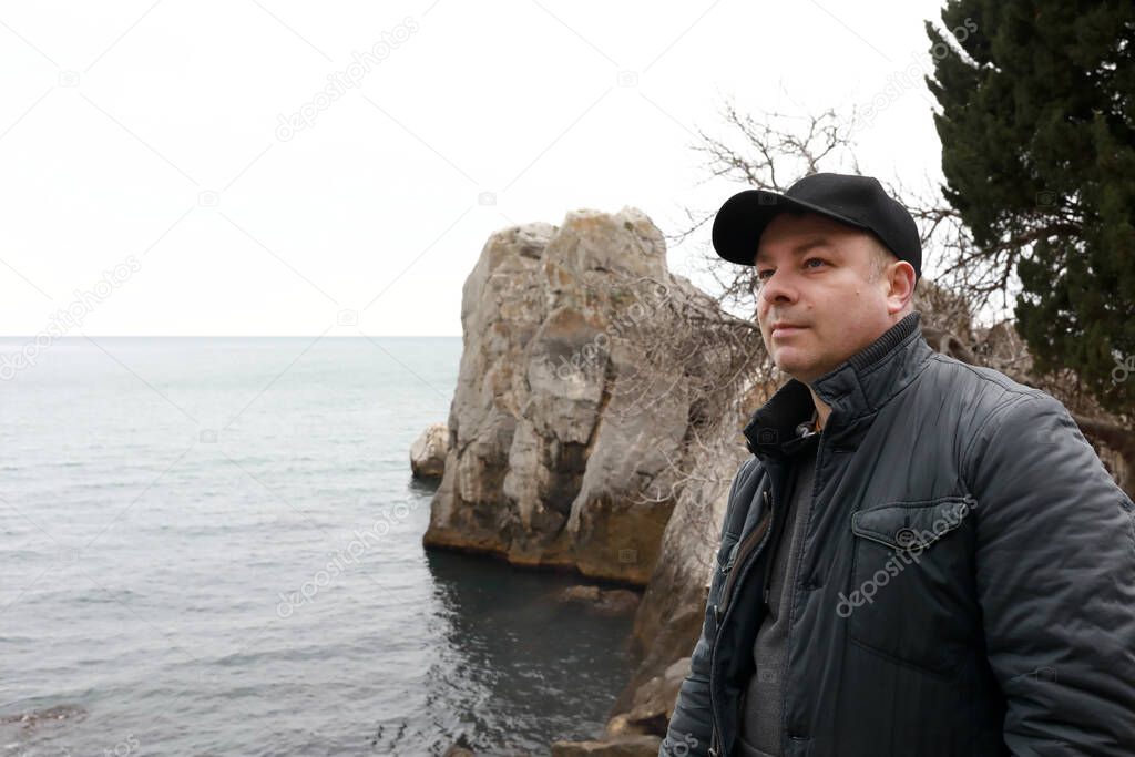 Man on background of Chekhov Bay in spring, Gurzuf, Crimea