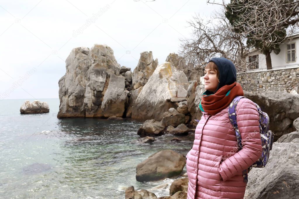 Woman on background of Chekhov Bay in spring, Gurzuf, Crimea