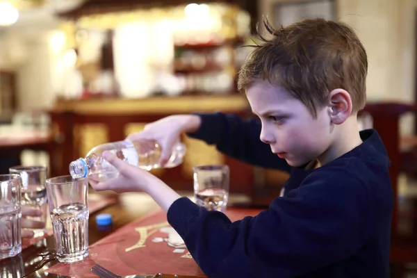 Dítě Nalévání Vody Láhve Restauraci — Stock fotografie