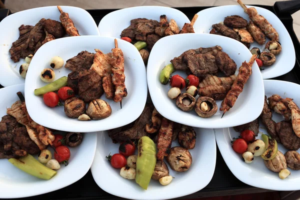 Plates with grilled meat and vegetables — Stock Photo, Image