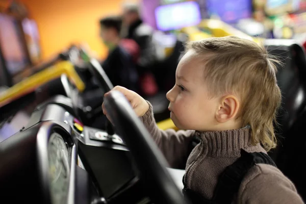 Kid playing with car simulator — Stock Photo, Image