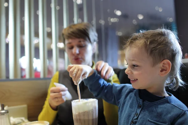 Boy eating foam of milkshake — Stock Photo, Image