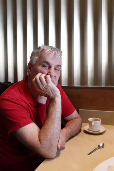 Pensive man in a restaurant — Stock Photo, Image