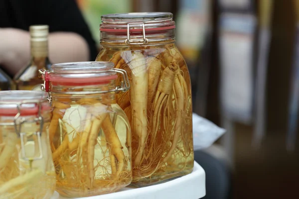 Jar with ginseng root — Stock Photo, Image