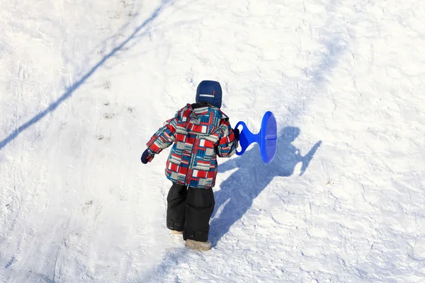 Kid lezení na zasněženém kopci — Stock fotografie