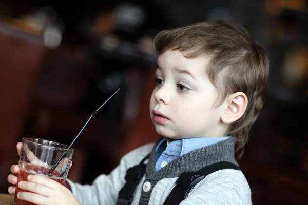 Portrail of thinking boy with red juice — Stock Photo, Image