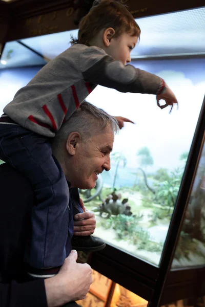 Grandfather with his grandson at the exhibition — Stock Photo, Image