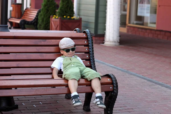 Boy resting on a bench — Stock Photo, Image