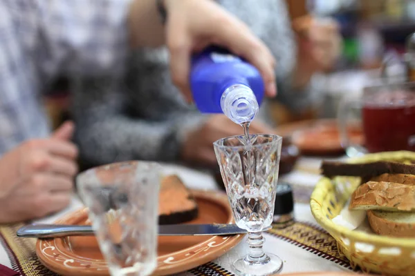 Person pouring vodka — Stock Photo, Image