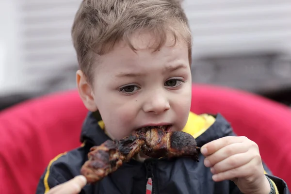 Enfant mangeant du kebab sur une brochette — Photo