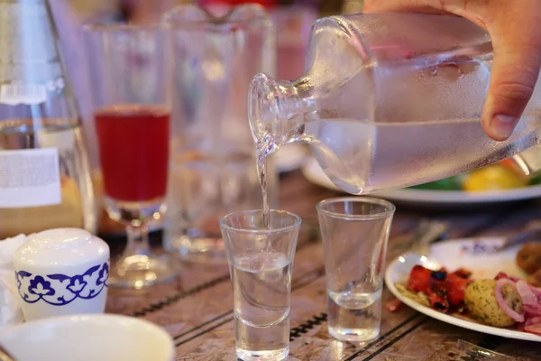 Person filling vodka — Stock Photo, Image