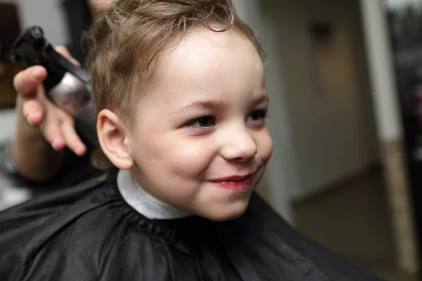 Lächelndes Kind beim Friseur — Stockfoto