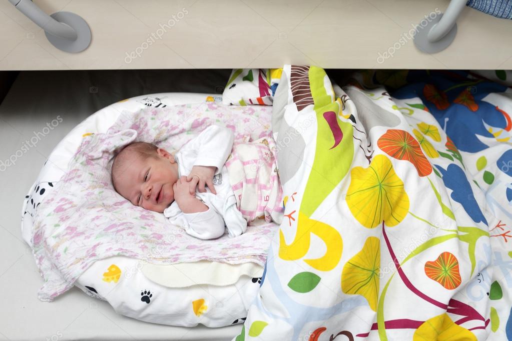 Newborn baby boy lying on the bed