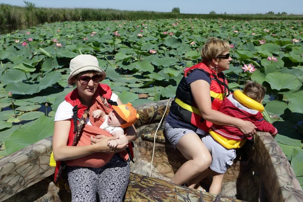 Tourists looking at Indian lotus — Stock Photo, Image