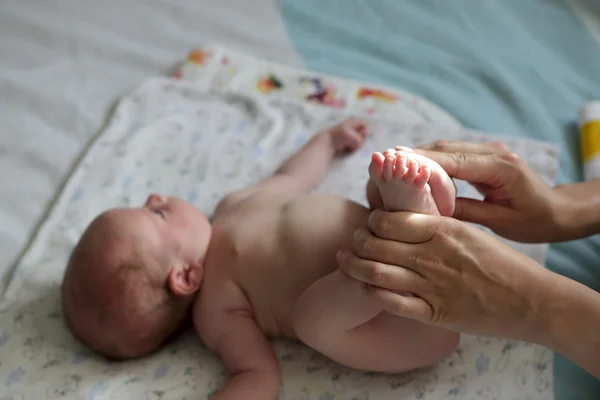 Newborn boy doing exercises — Stock Photo, Image