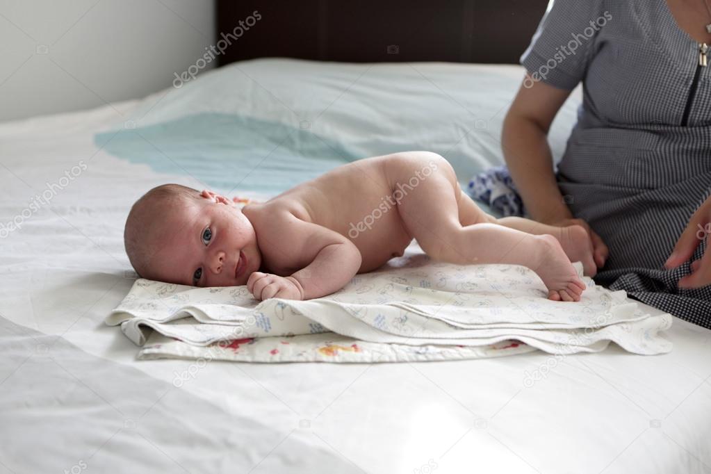 Mother teaches her son to crawl