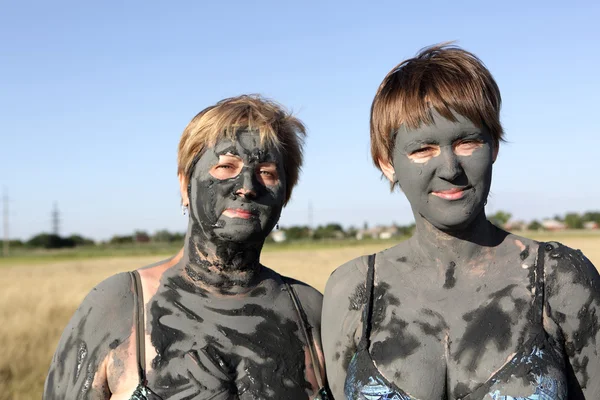 Twee vrouwen bedekt modder — Stockfoto