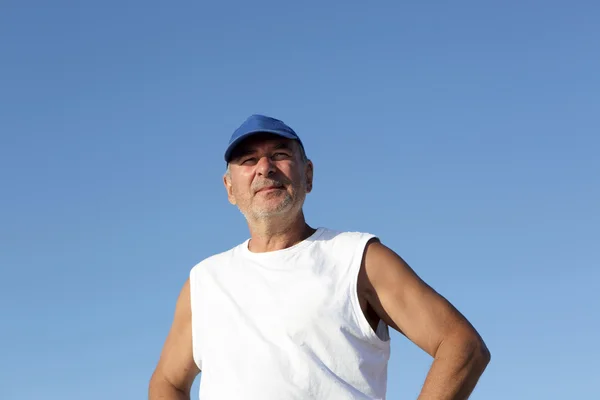 Senior man on the sky background — Stock Photo, Image