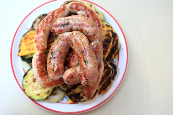 Fresh grilled sausages on the plate — Stock Photo, Image