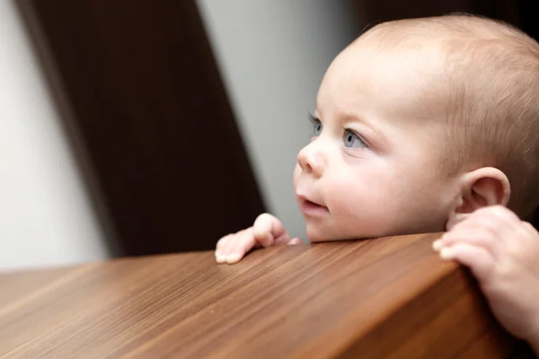 Curious boy and a chest of drawers — Stock Photo, Image