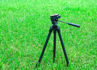 tripod for the camera on natural background clipart